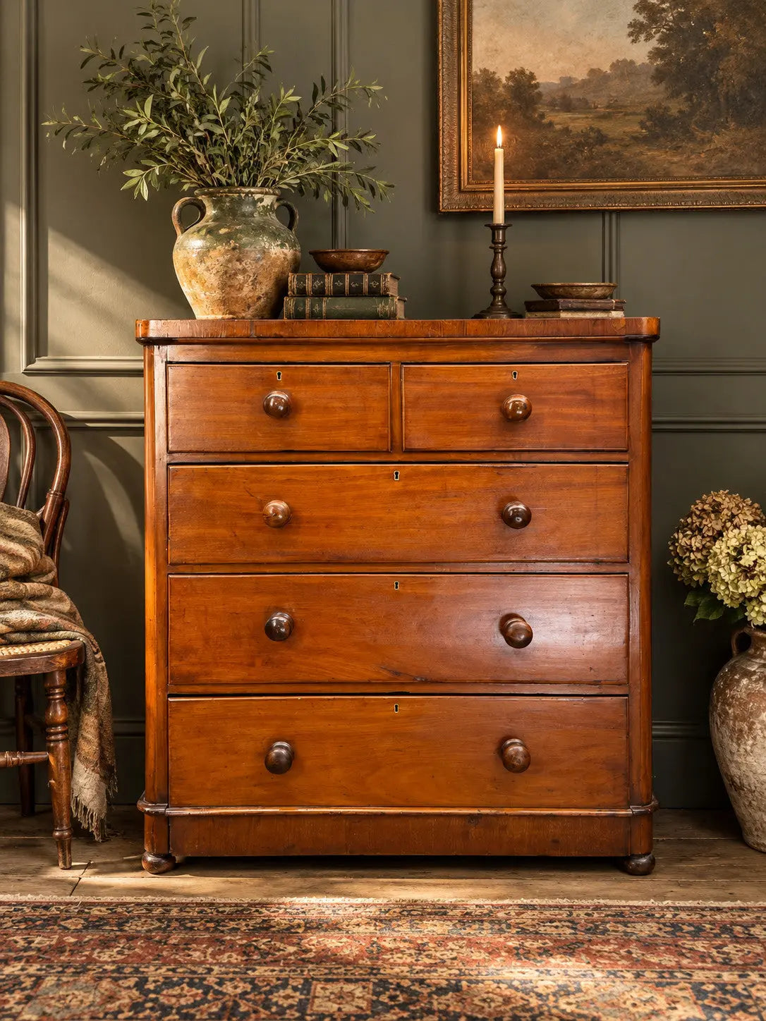 Antique brown mahogany chest of drawers with rounded corners and wooden knob handles.