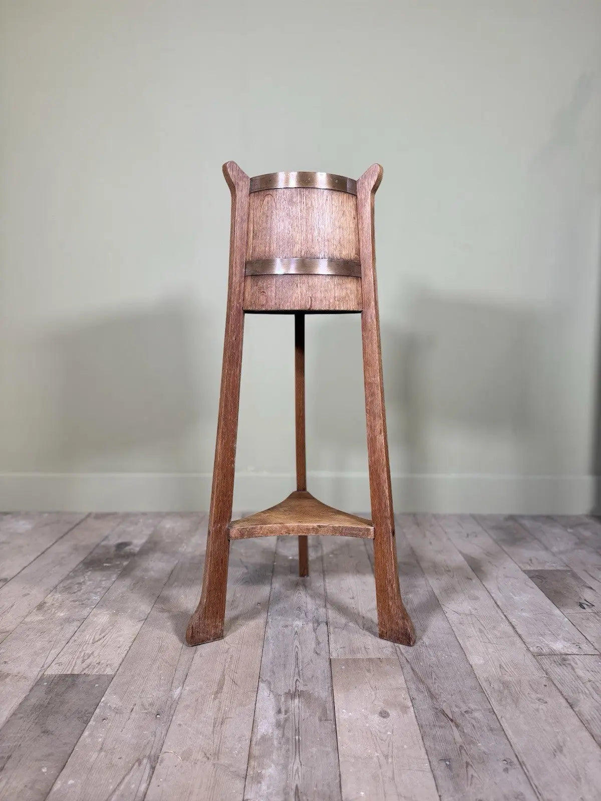 R.A. Lister antique oak jardinière plant stand coopered barrel with copper banding and splayed legs.