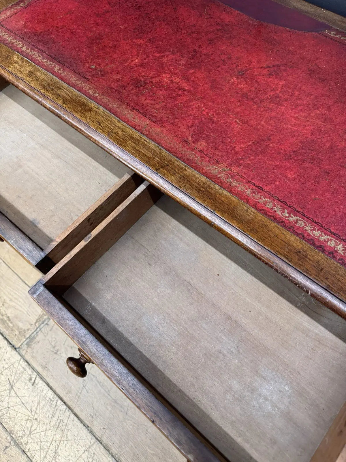 Victorian mahogany writing desk brown with red leather surface and four drawers.