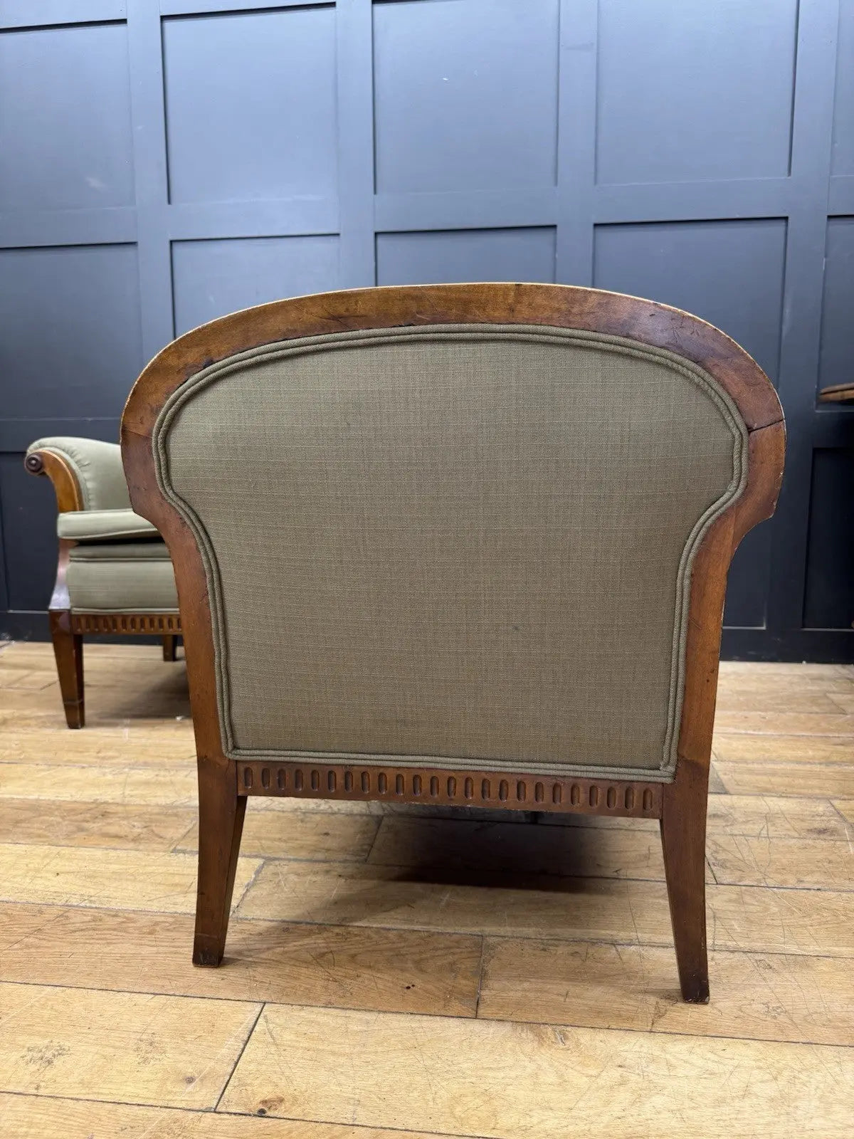 French's green Art Deco armchairs with walnut scroll arms and tapered legs.
