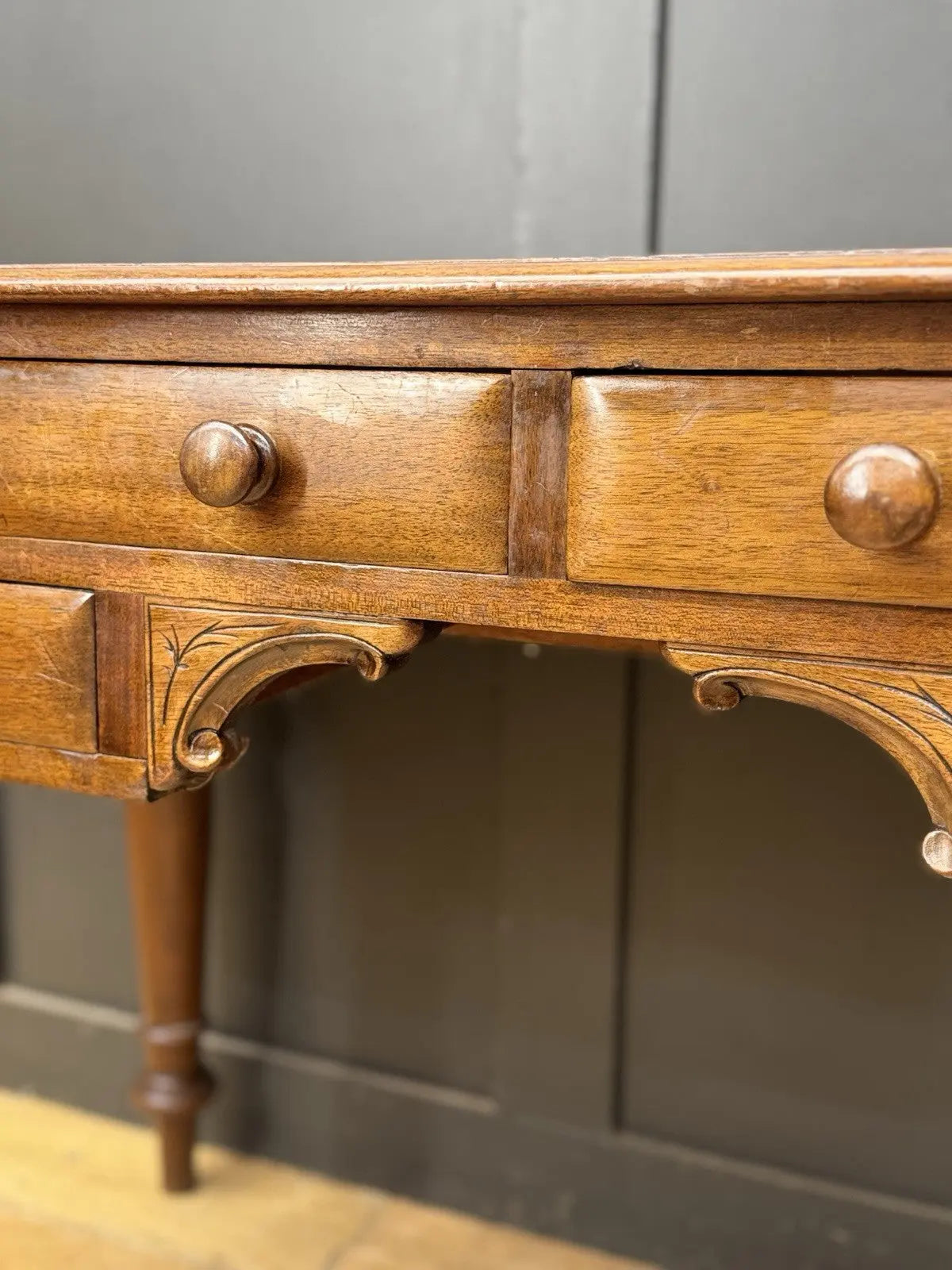 Victorian mahogany writing desk brown with red leather surface and four drawers.
