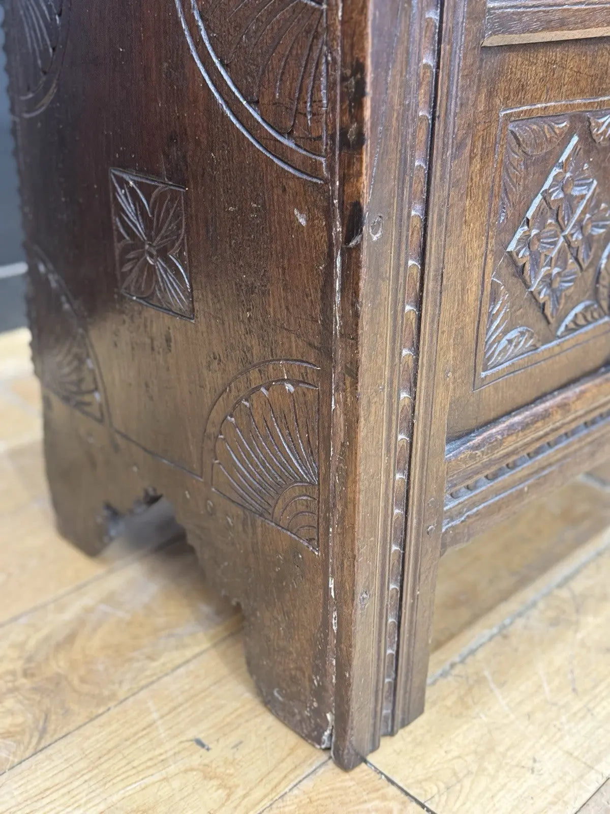 Georgian carved oak hope chest brown with floral motifs and iron hinges.