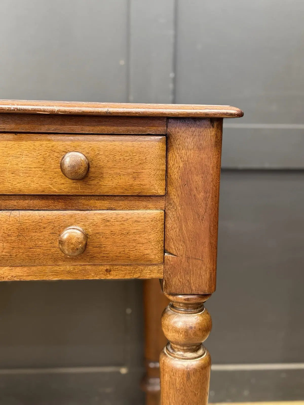 Victorian mahogany writing desk brown with red leather surface and four drawers.