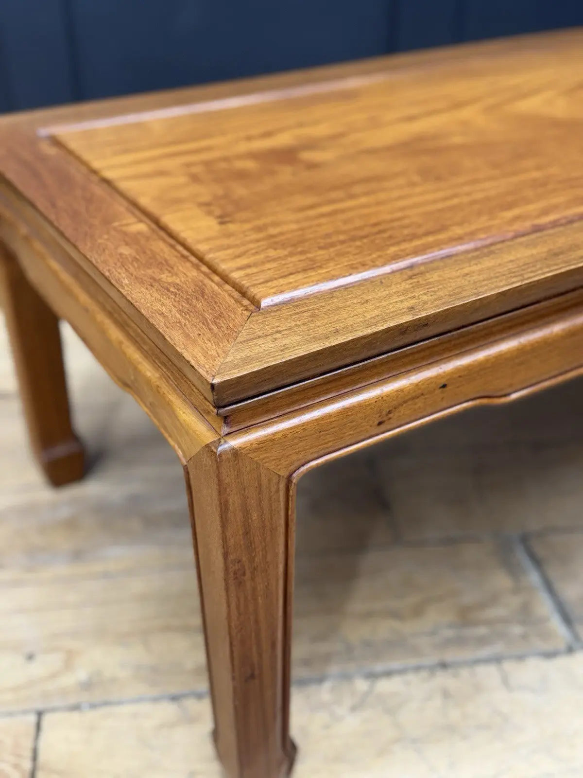 Contemporary Chinese hardwood coffee table brown rectangular top with framed construction and square legs.