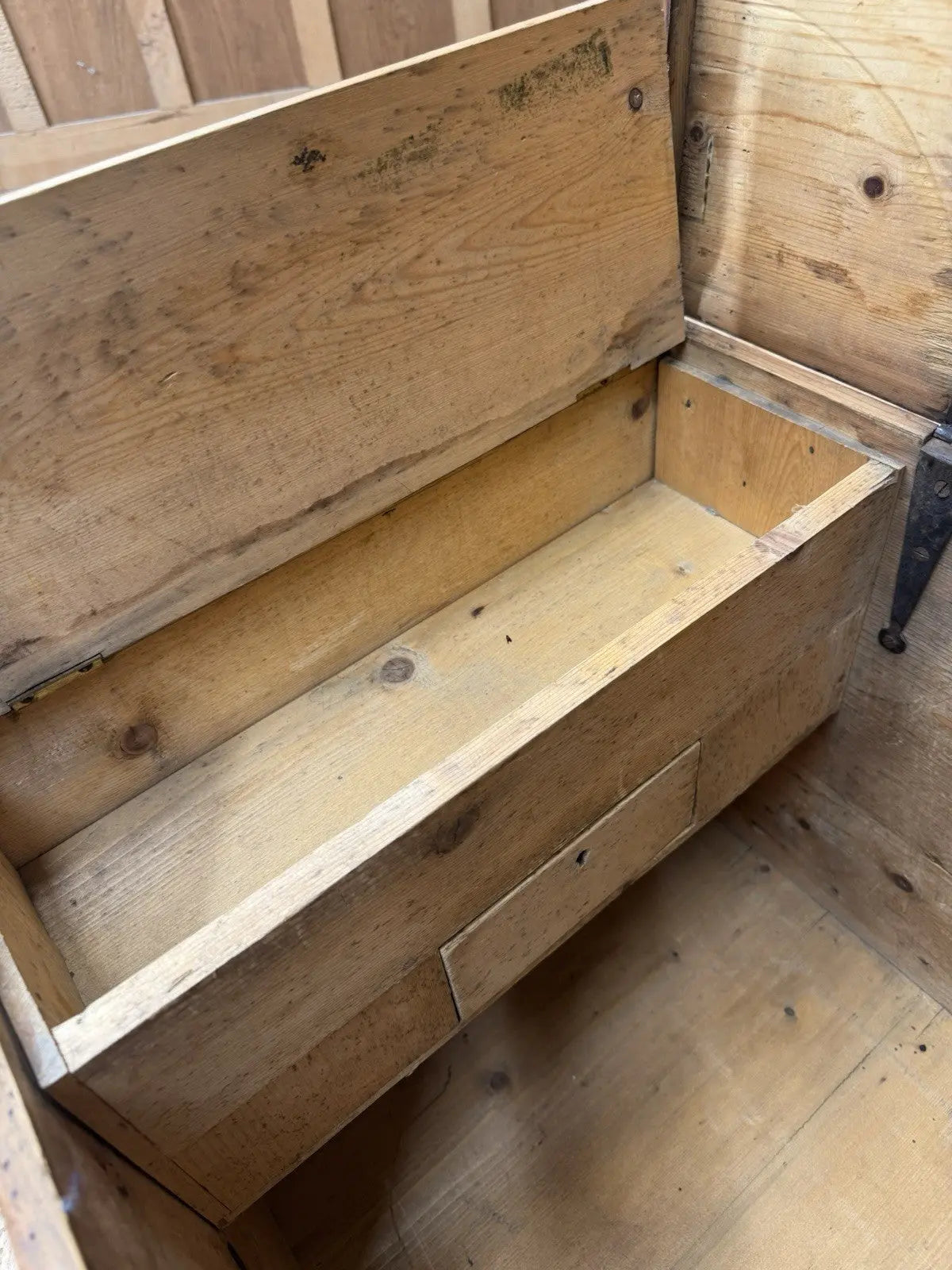 Antique pine hope chest with honey-coloured finish, iron handles, and dovetailed joints.