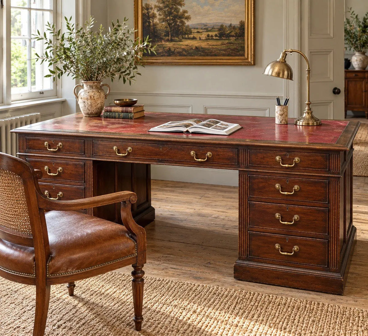 Twin antique mahogany writing desk with red leather top and brass swan-neck handles.