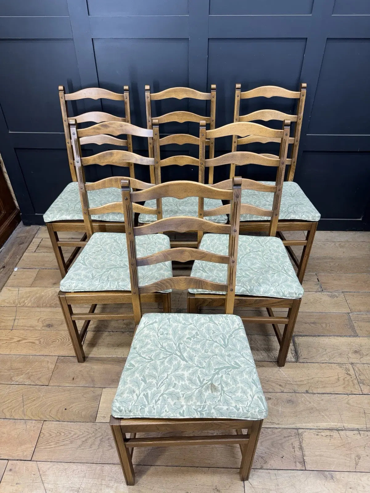 Ercol vintage ladderback dining chairs brown elm beech with green botanical patterned seat pads.