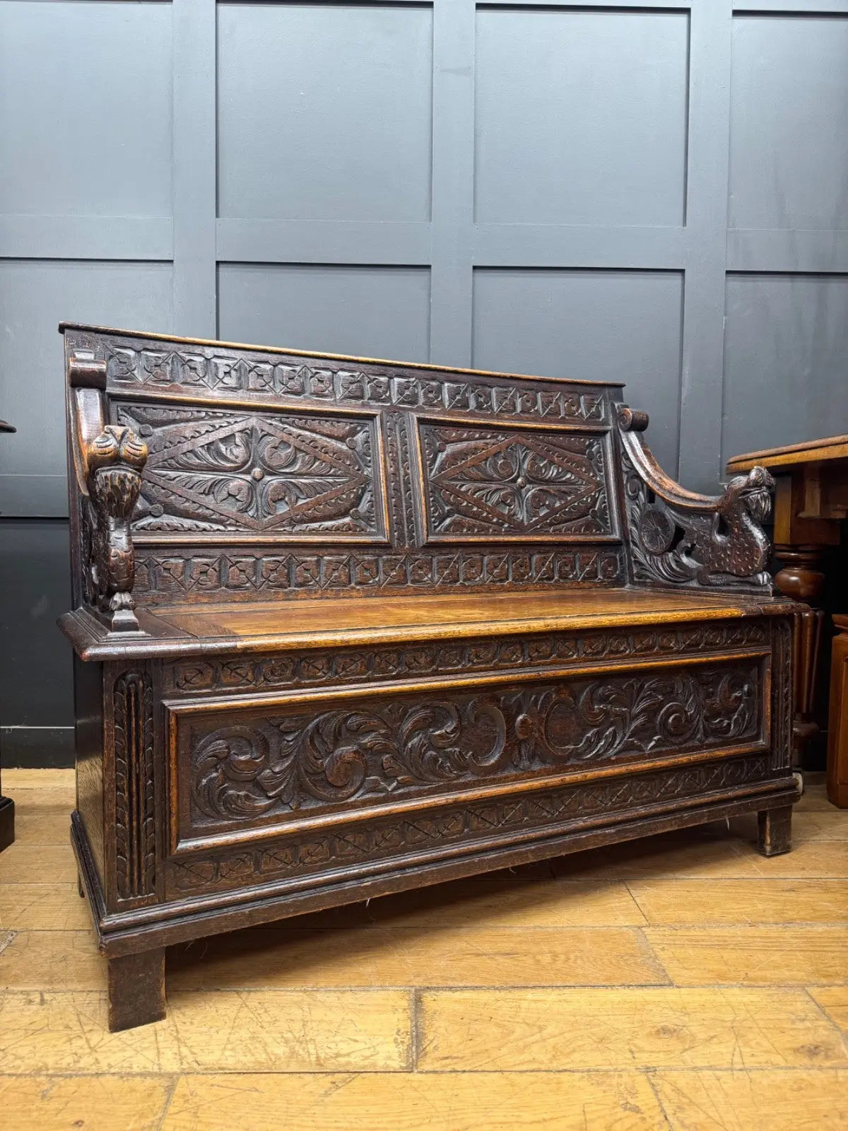 Victorian carved oak hall bench, brown, intricate Gothic Revival carvings and mythical figures.