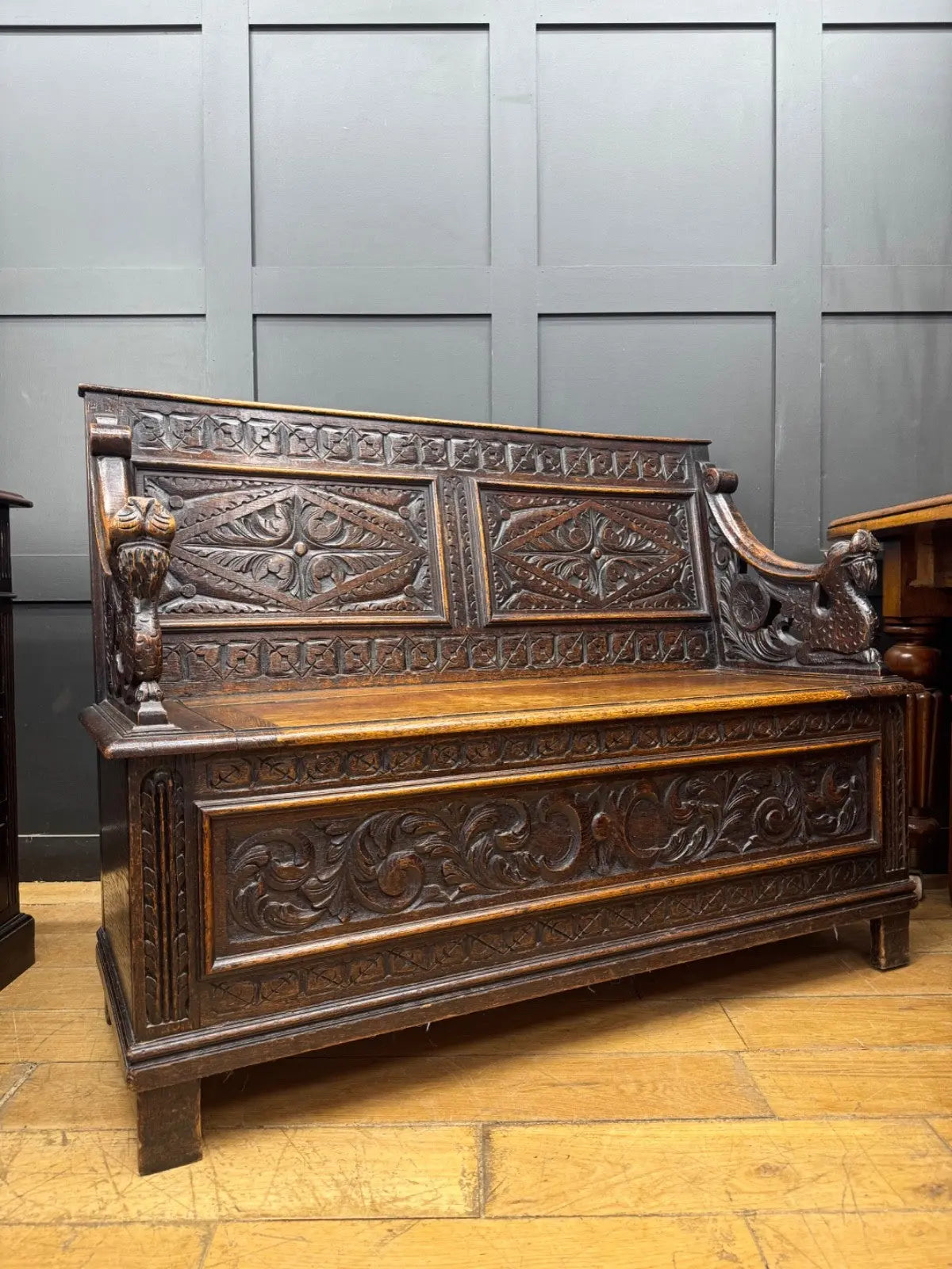 Victorian carved oak hall bench, brown, intricate Gothic Revival carvings and mythical figures.