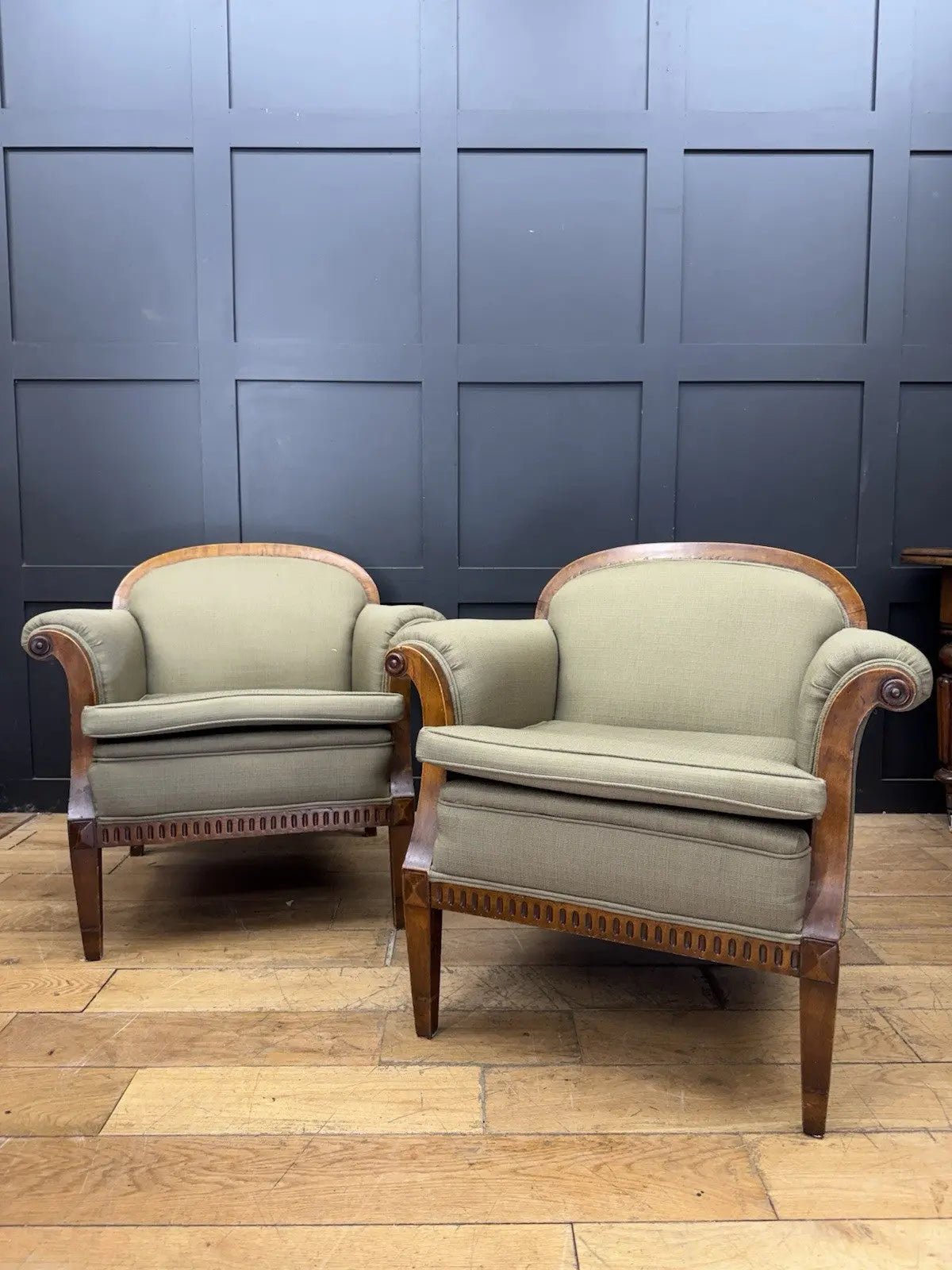 French's green Art Deco armchairs with walnut scroll arms and tapered legs.