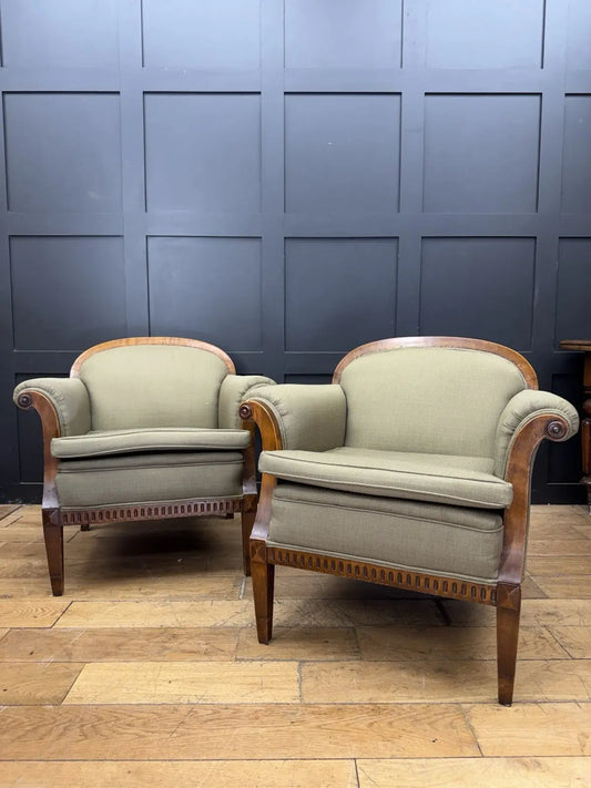 French's green Art Deco armchairs with walnut scroll arms and tapered legs.