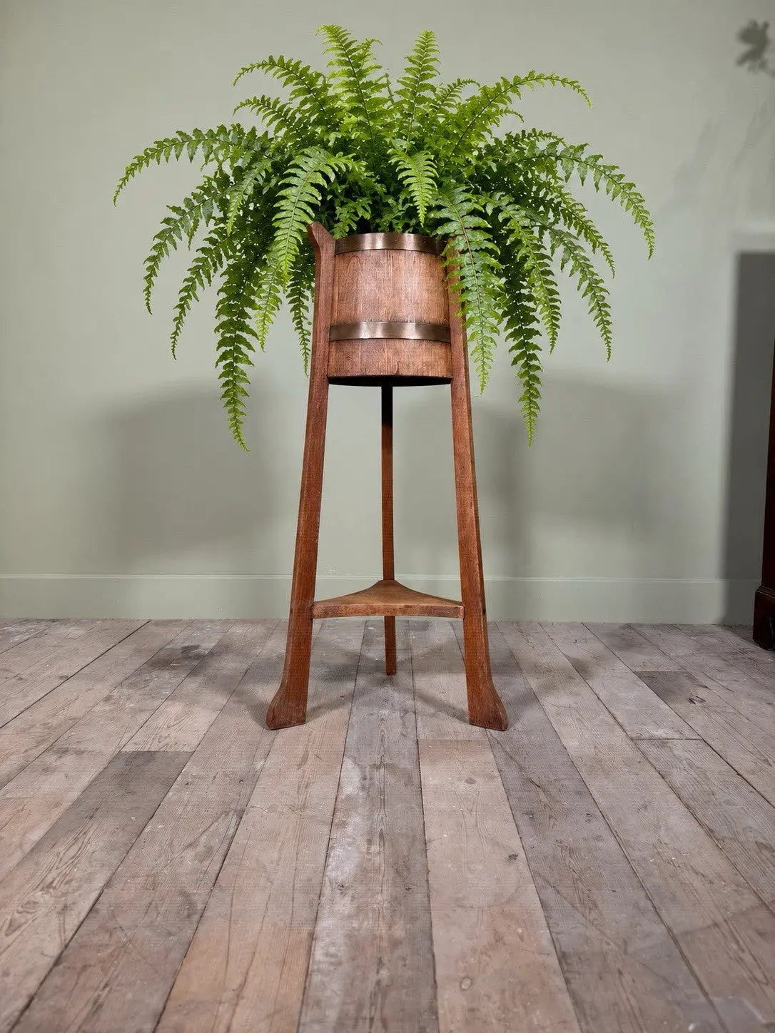 R.A. Lister antique oak jardinière plant stand coopered barrel with copper banding and splayed legs.