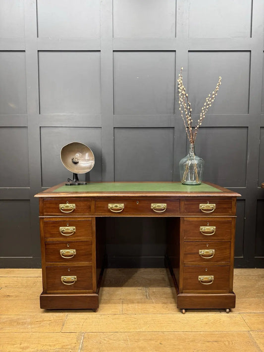 Victorian walnut writing desk brown with green leather top and brass drop handles.