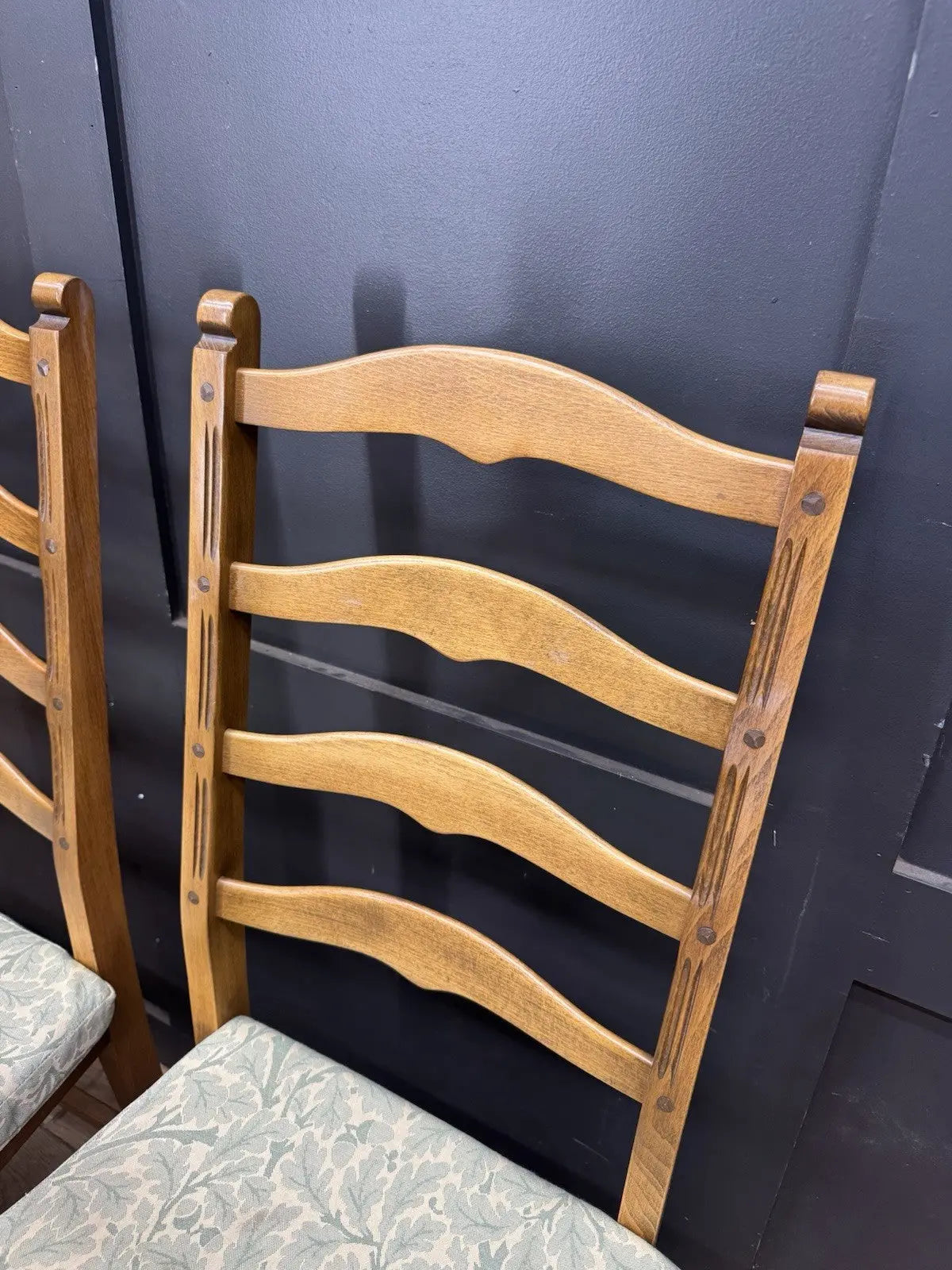 Ercol vintage ladderback dining chairs brown elm beech with green botanical patterned seat pads.