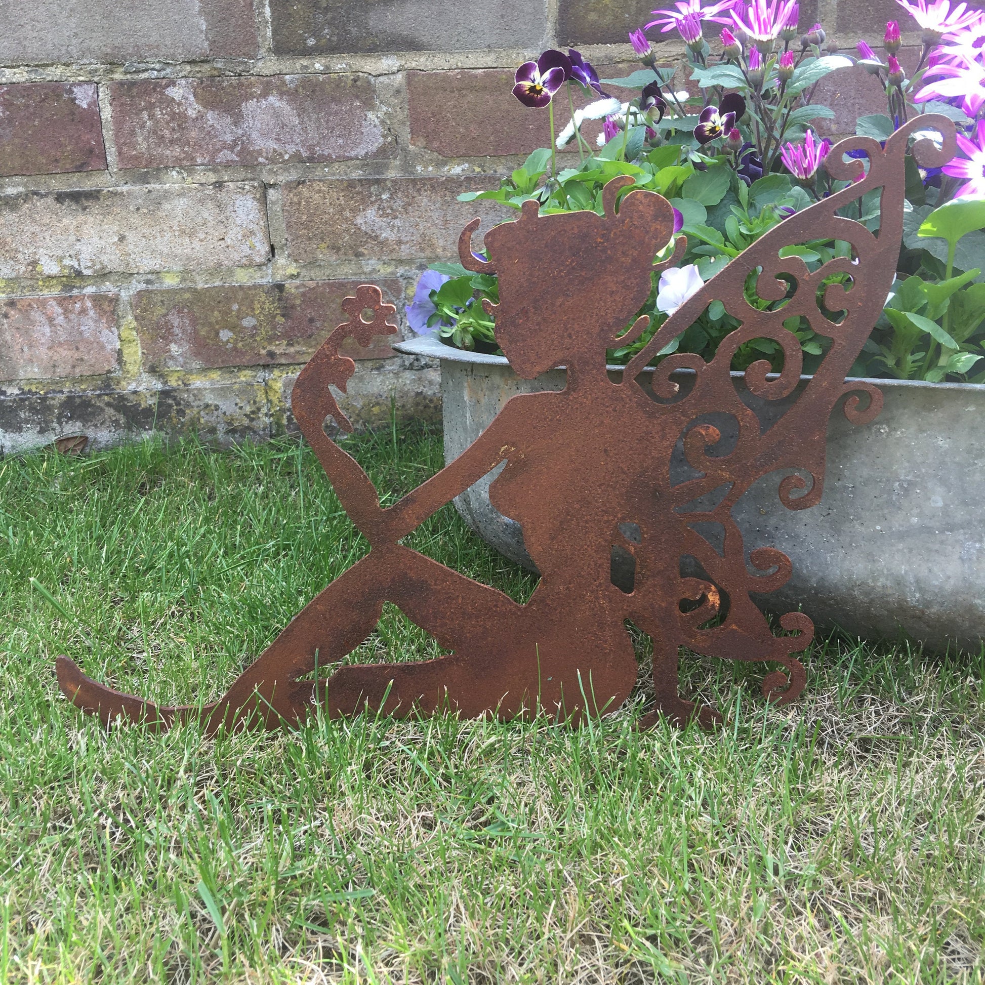 Rusty metal sitting fairy garden decoration