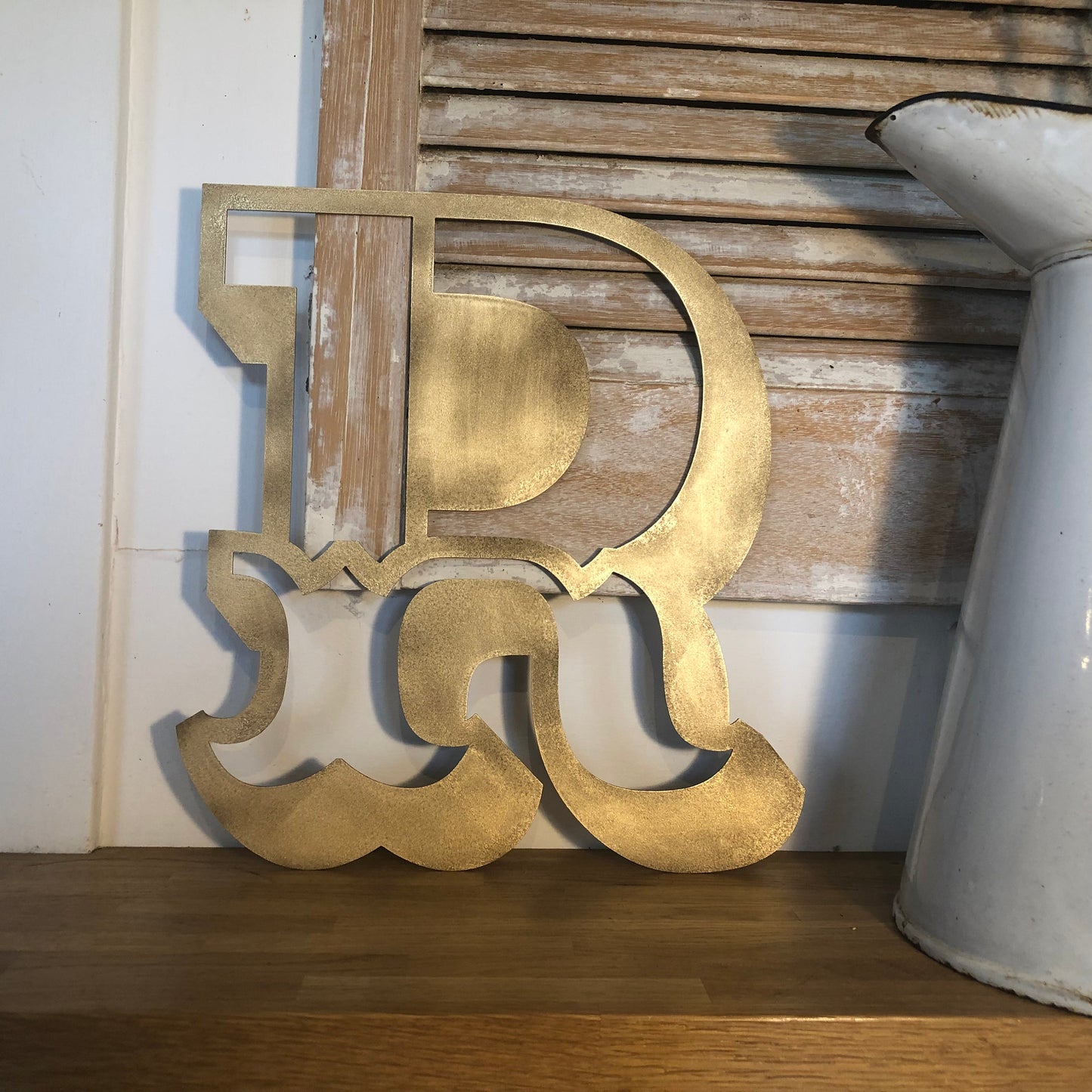 Distressed gold carnival style letter R