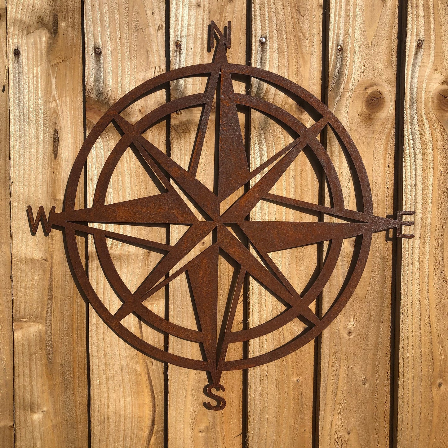 rusty metal compass wall art