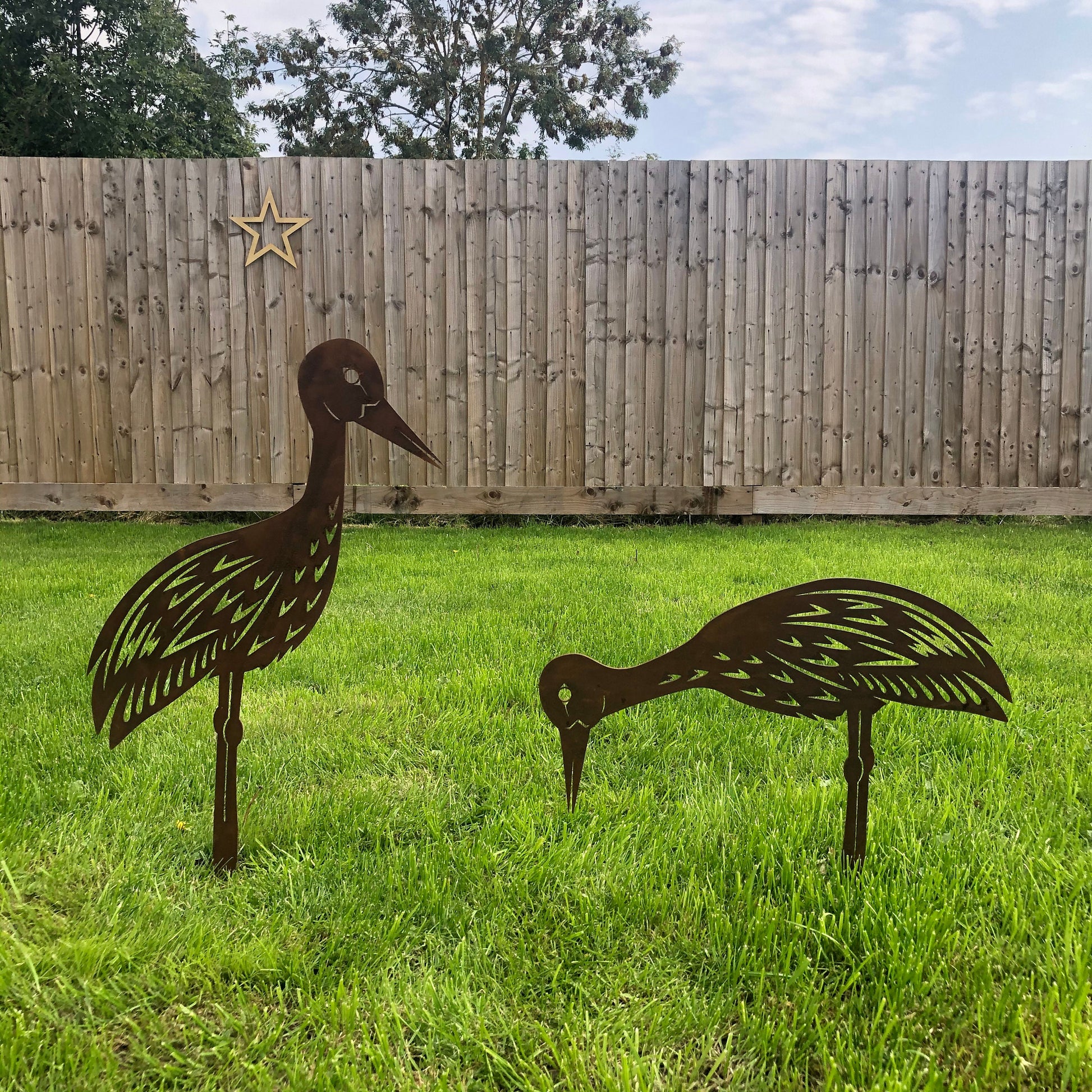 Pair of rusty metal garden storks