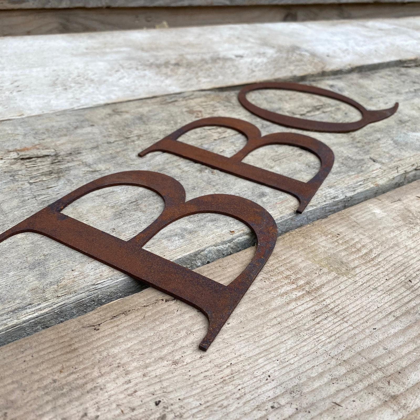 Rusty metal classic style metal lettering spelling out BBQ