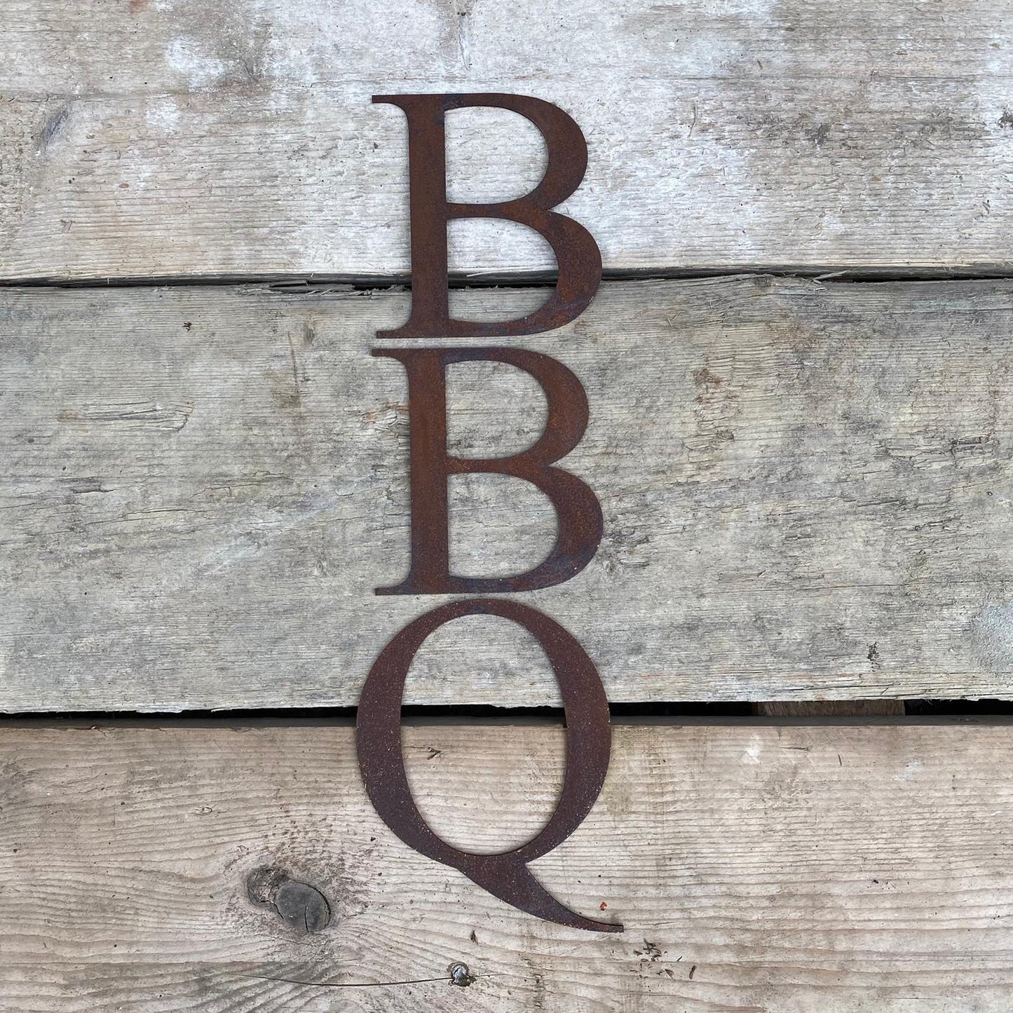 Rusty metal classic style lettering spelling out BBQ