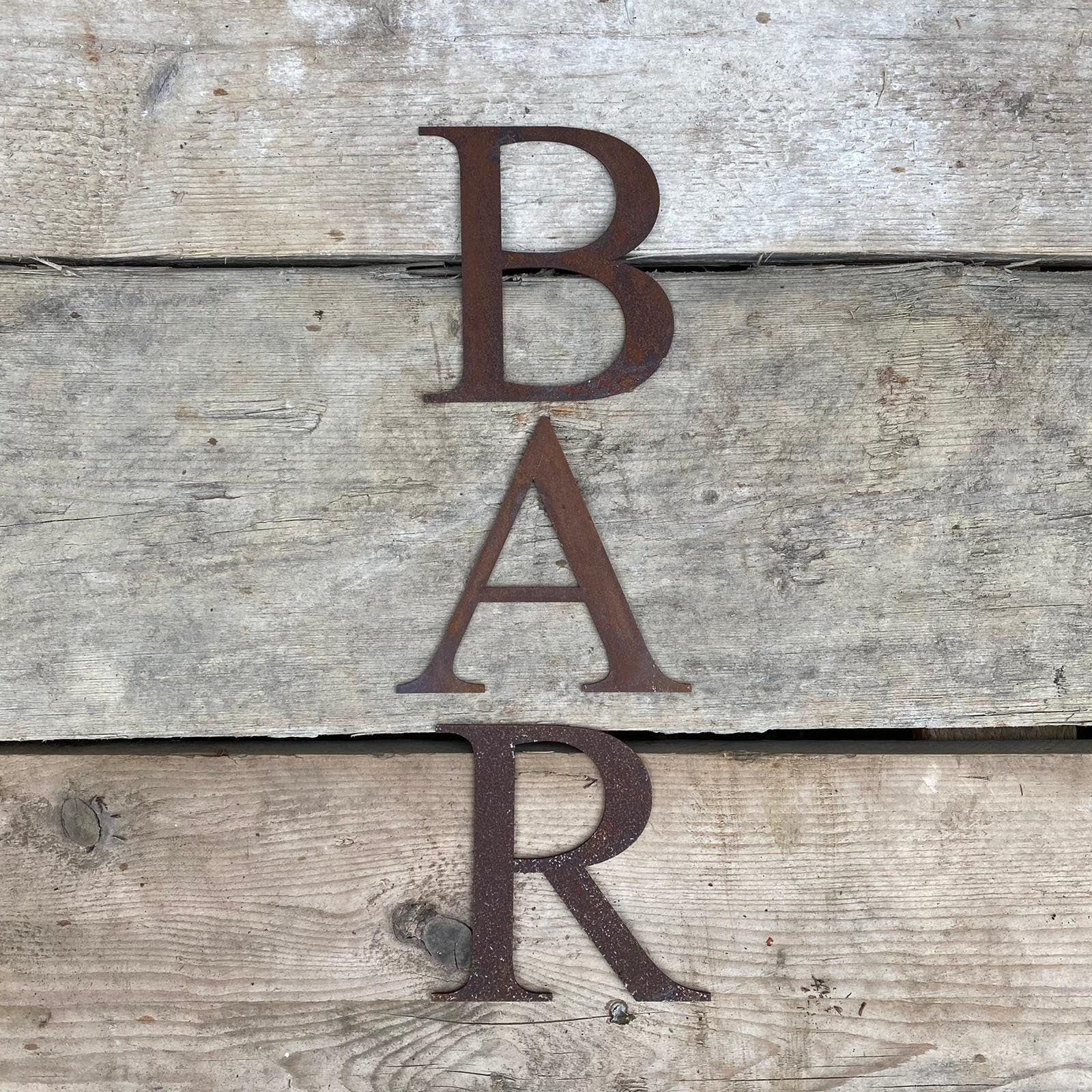 Rusty metal classic style lettering spelling out BAR
